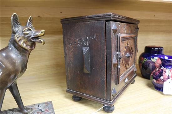 An inlaid oak spice cabinet, carved with the date, 1672 W.29cm